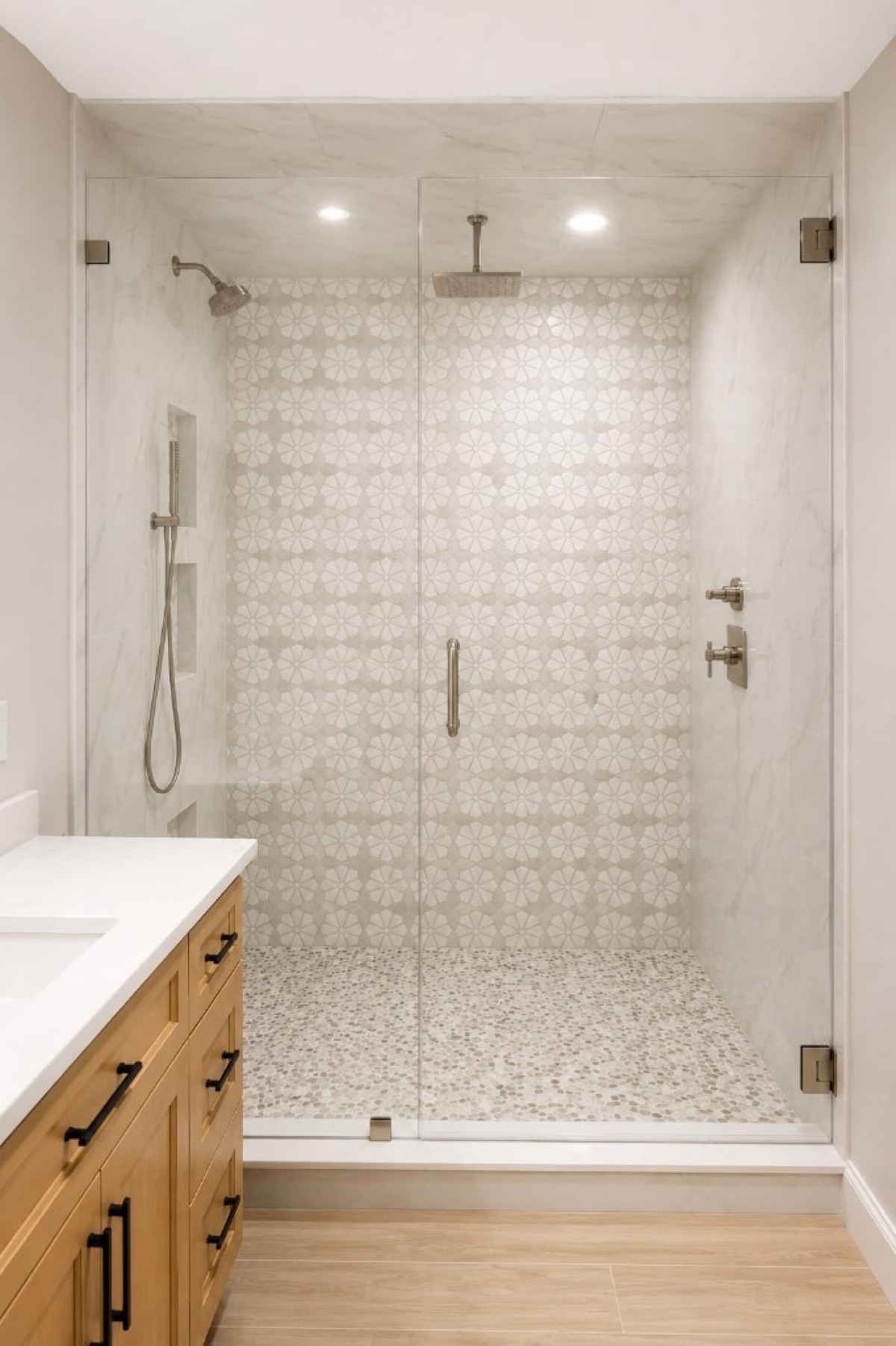 Walk-in shower with star mosaic feature wall, pebble floor and marble-look tile